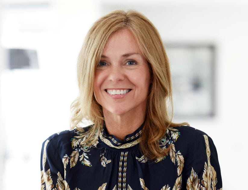 Portrait of Adele Parks smiling wearing a floral black top