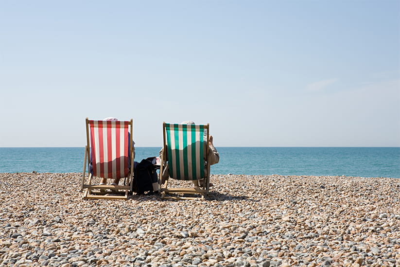 People in deckchairs at the beach