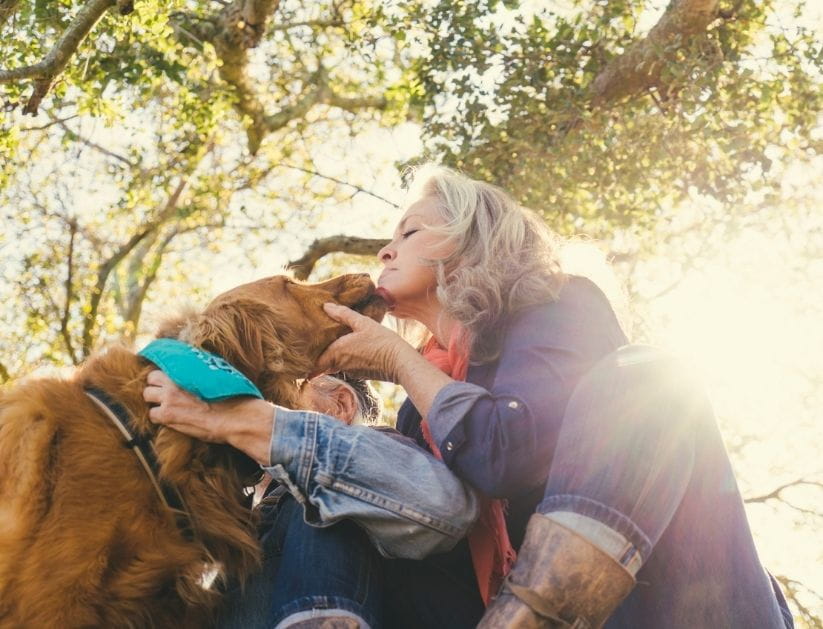  Mature woman with dog on sunny day