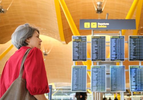 A lady looks at the airport departure boards