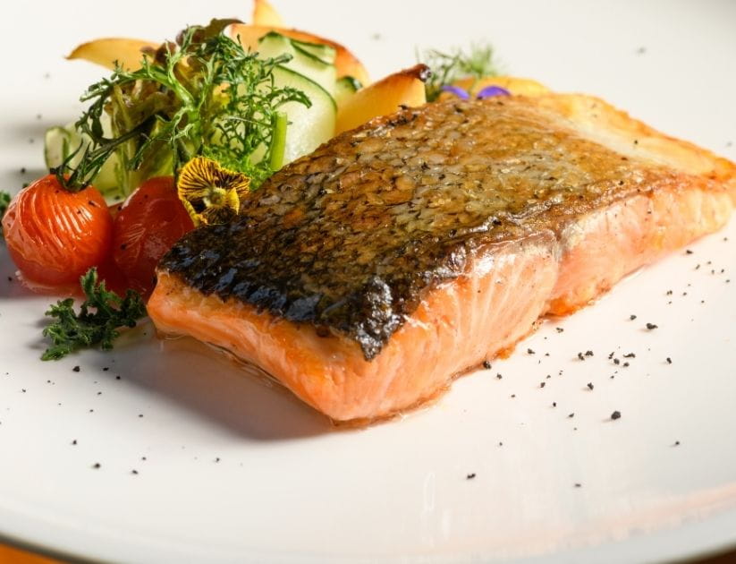 Pan fried salmon with vegetables on a plate