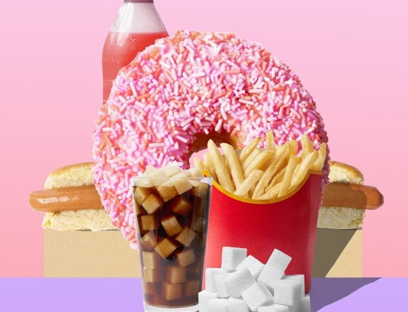 A variety of highly processed foods, the collage has a fizzy drink, hot dogs, chips and doughnuts 