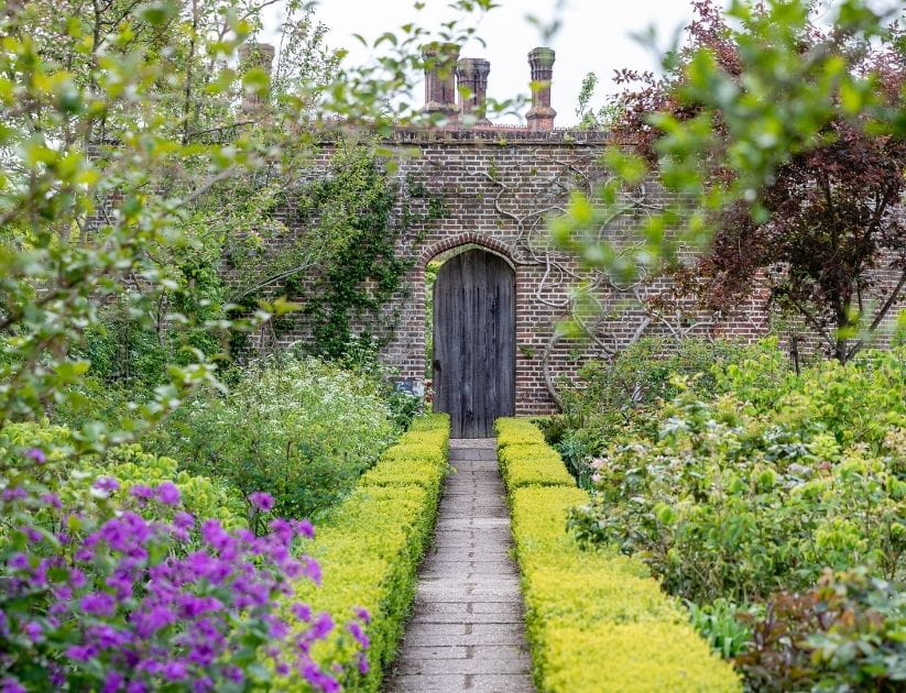A straight garden path in Sissinghurst castle garden in England