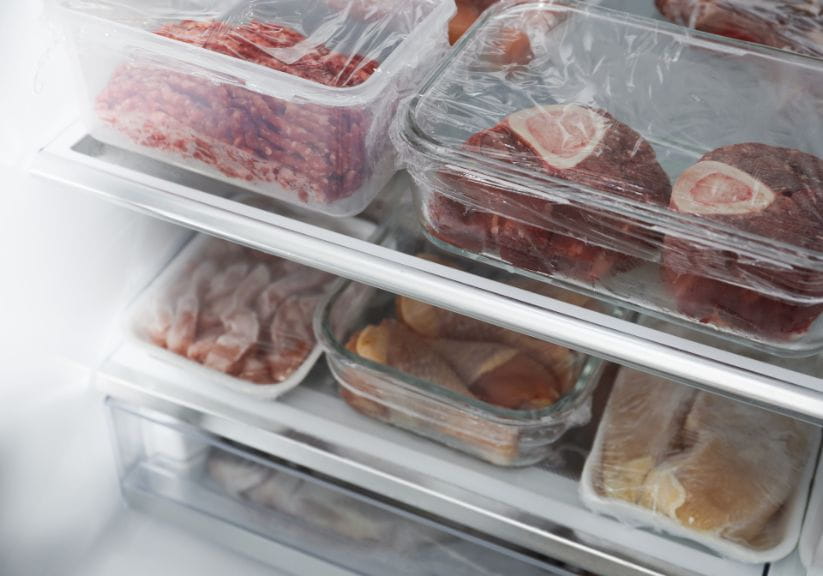 Different types of raw meat stored in the fridge