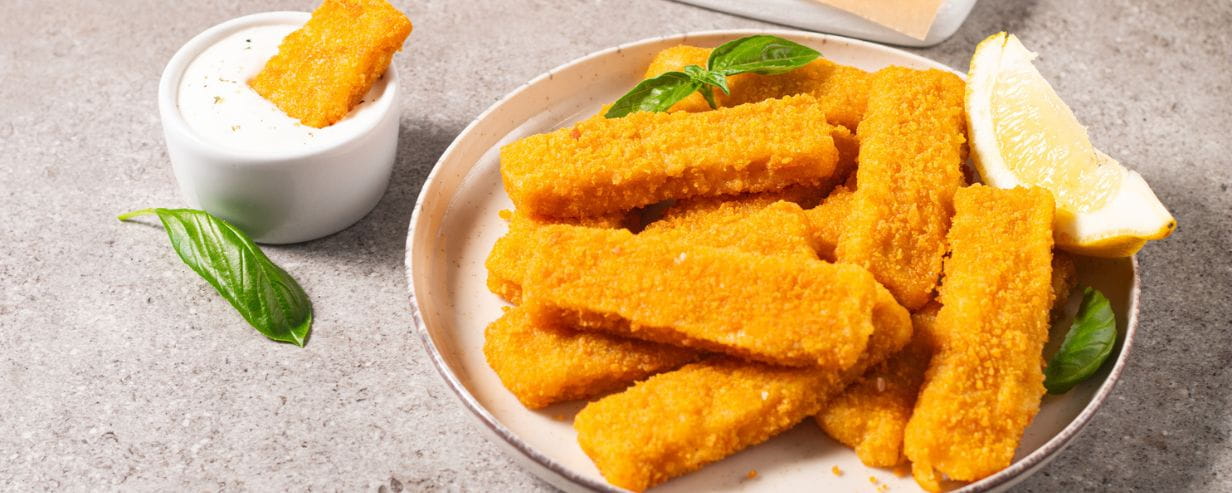 Plate of fish fingers with lemon and garlic sauce