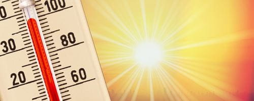 hot thermometer with blinding sun next to it 
