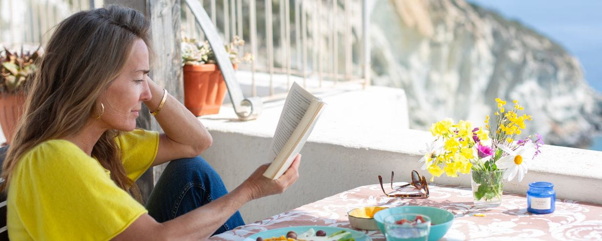 Woman sitting outside reading a book