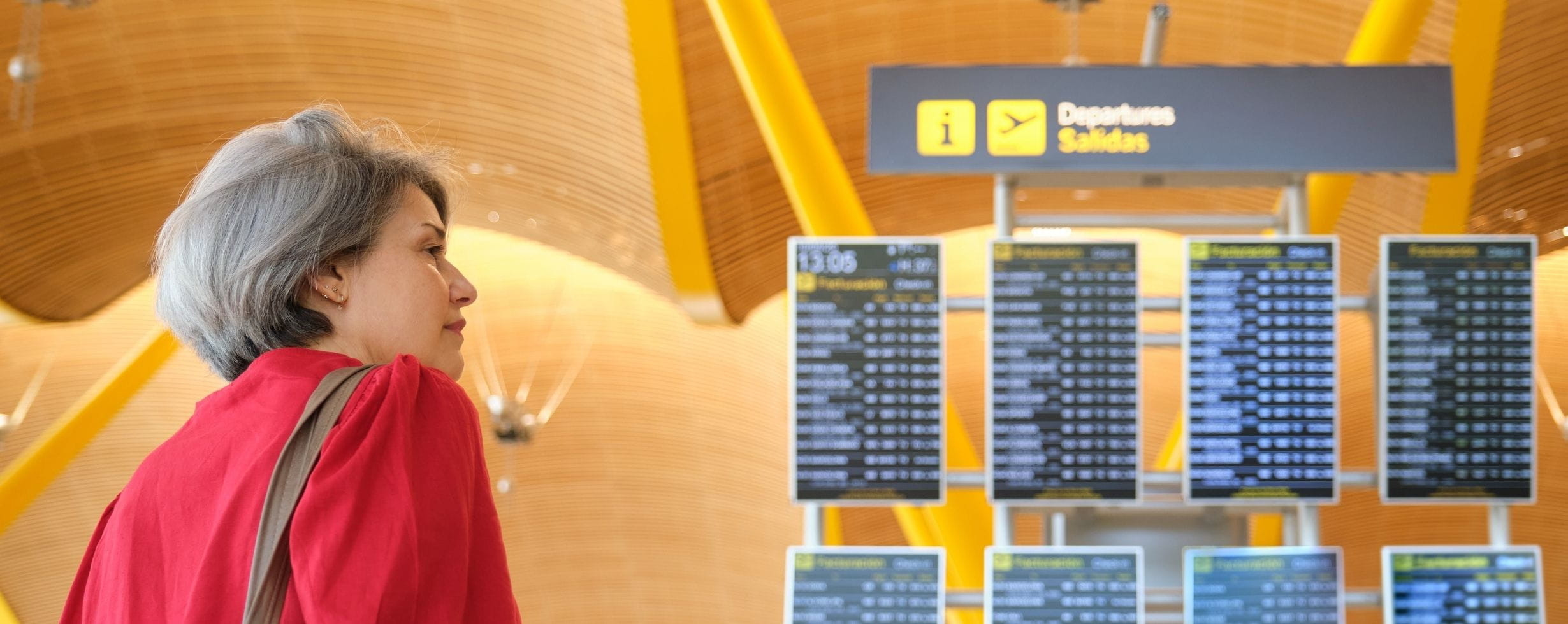 A lady looks at the airport departure boards