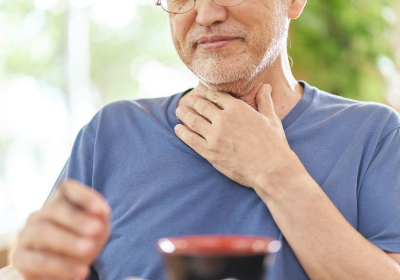 A man struggles to swallow food