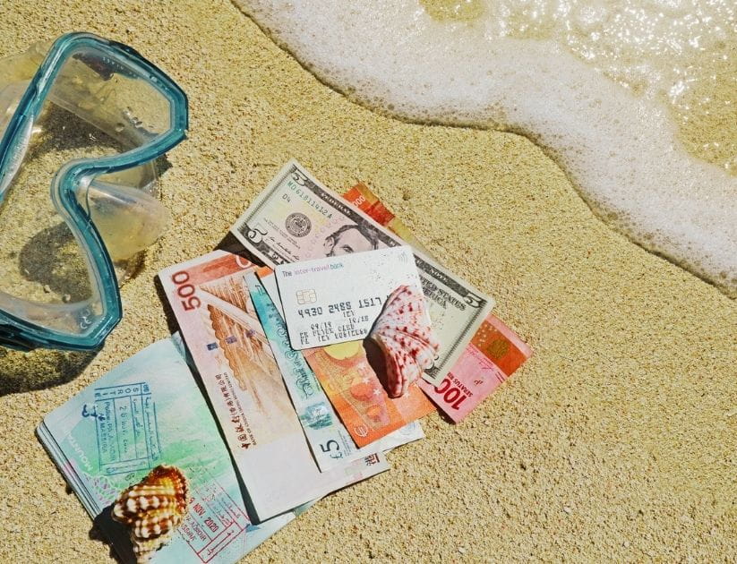 Cash and card on a beach