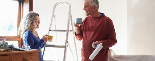 A couple enjoy a cup of tea while renovating their home