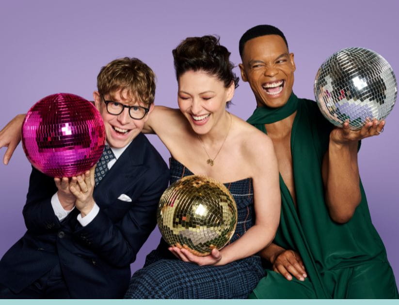 Strictly hosts pictured together holding disco balls