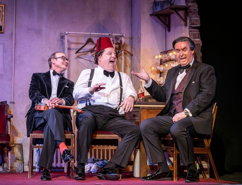 Cast members of 'The Last Laugh' show performing on stage