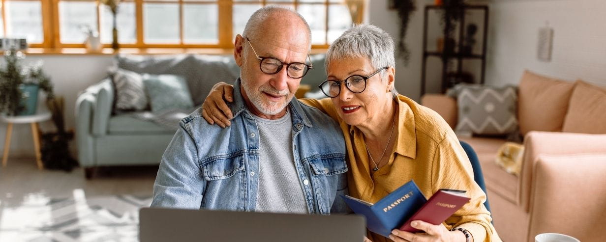 Senior couple planning vacation trip and searching information on internet