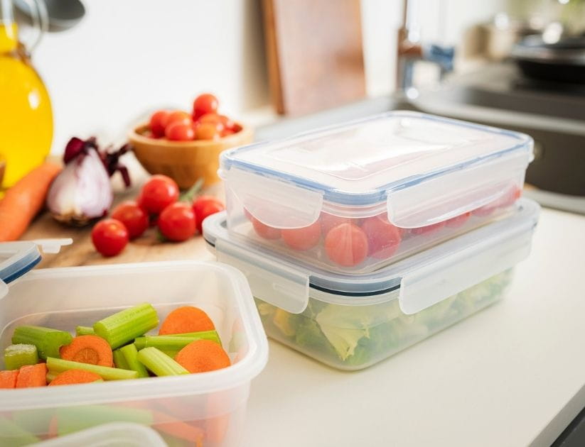  Airtight plastic food containers filled with vegetables on kitchen counter