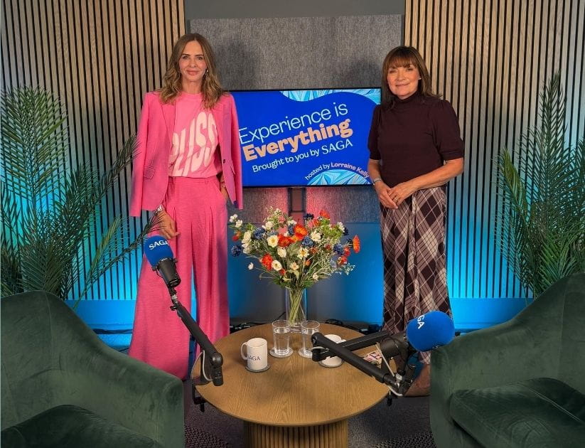 Trinny Woodall and Lorraine standing by a screen 