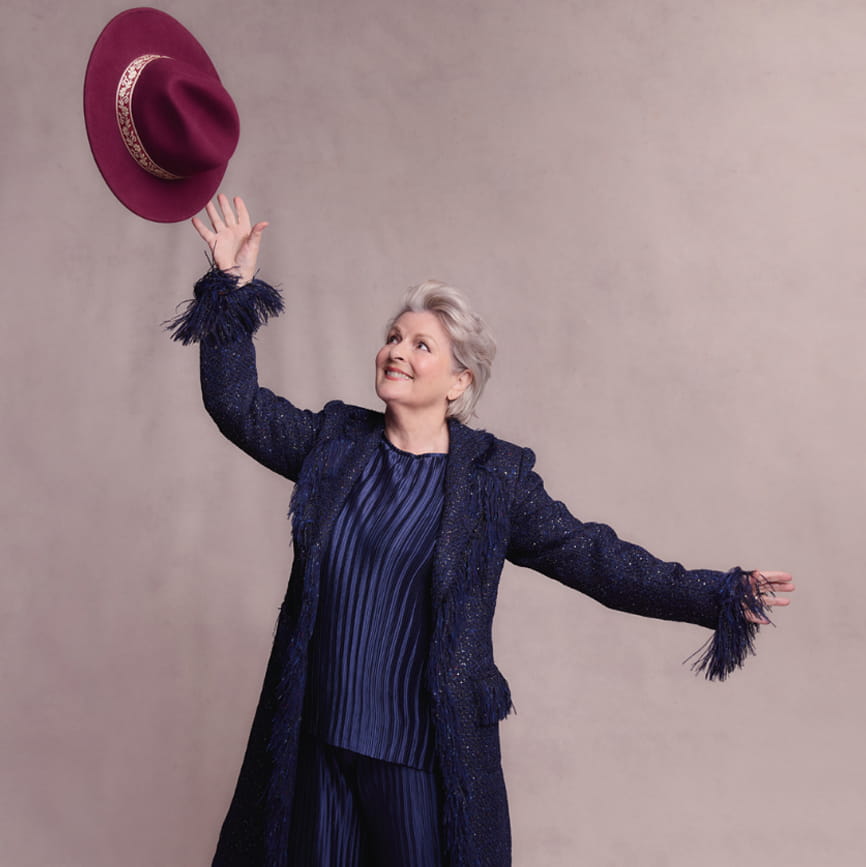 Brenda throwing a hat in the air