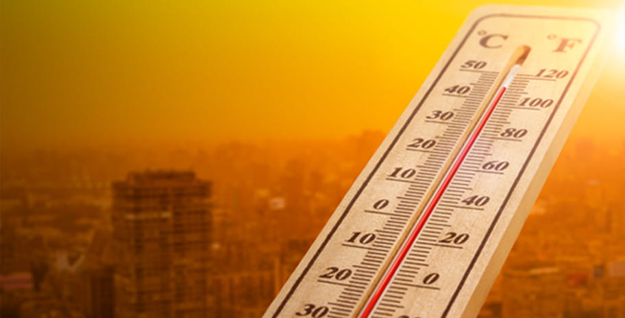 Thermometer showing the temperature over a warm city