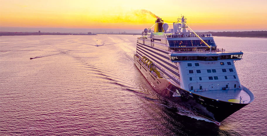The Spirit of Discovery at sea at sunset