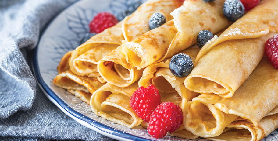 Pancakes on a plate with raspberries and blueberries