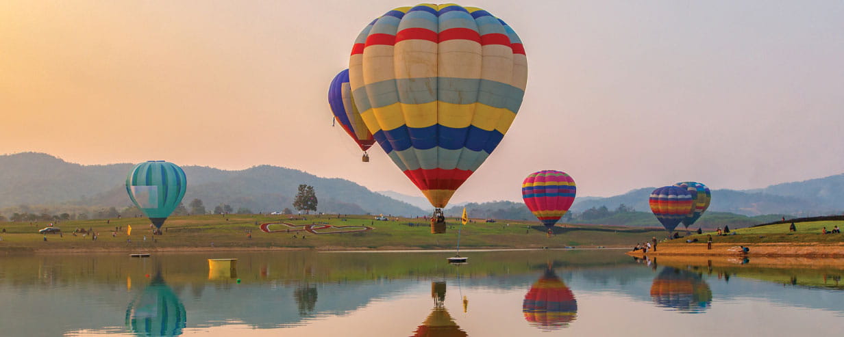 Hot air color balloon over lake with sunset time, Chiang Rai Province, Thailand