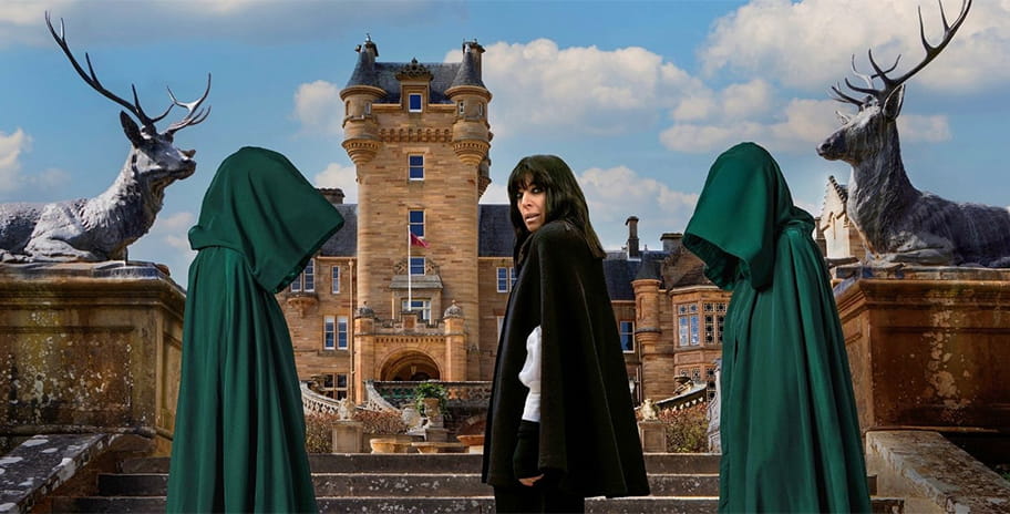 Claudia in front of The Traitors castle