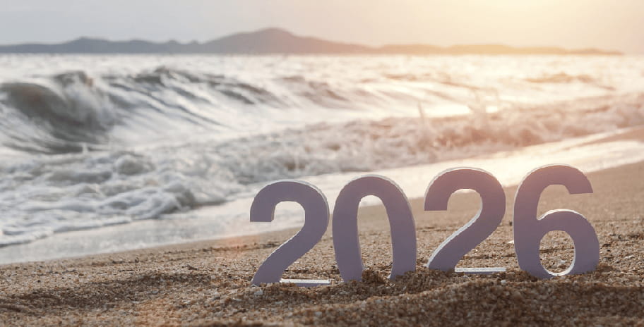 A sunny beach with the numbers 2026 sitting on the sand