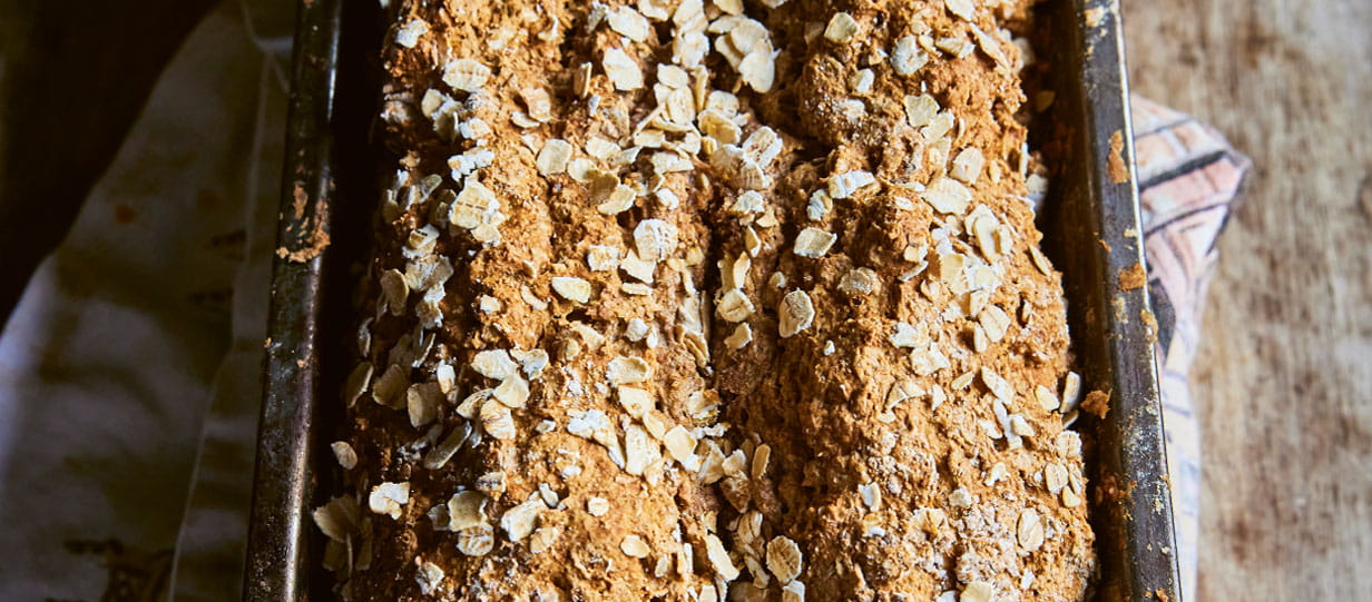 Close up of Clodagh McKennas Guinness and treacle brown soda bread in a baking tin