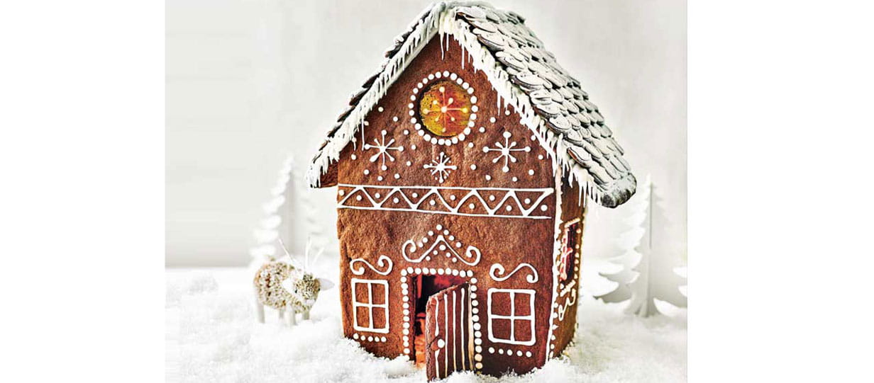 A gingerbread house decorated with piped icing