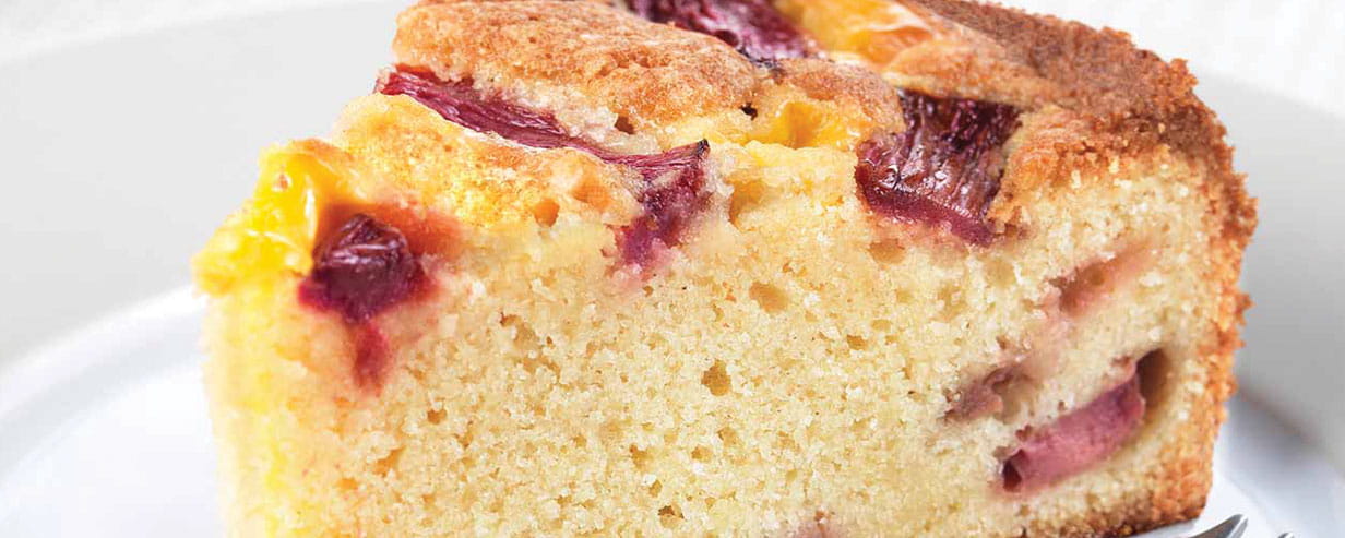 Close up of a slice of rhubarb and custard cake on a plate