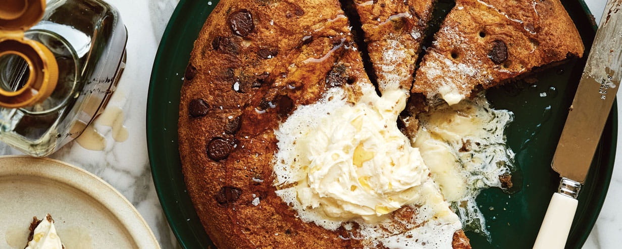 Edd Kimber's big chocolate chip pancake with whipped salted maple butter on a plate
