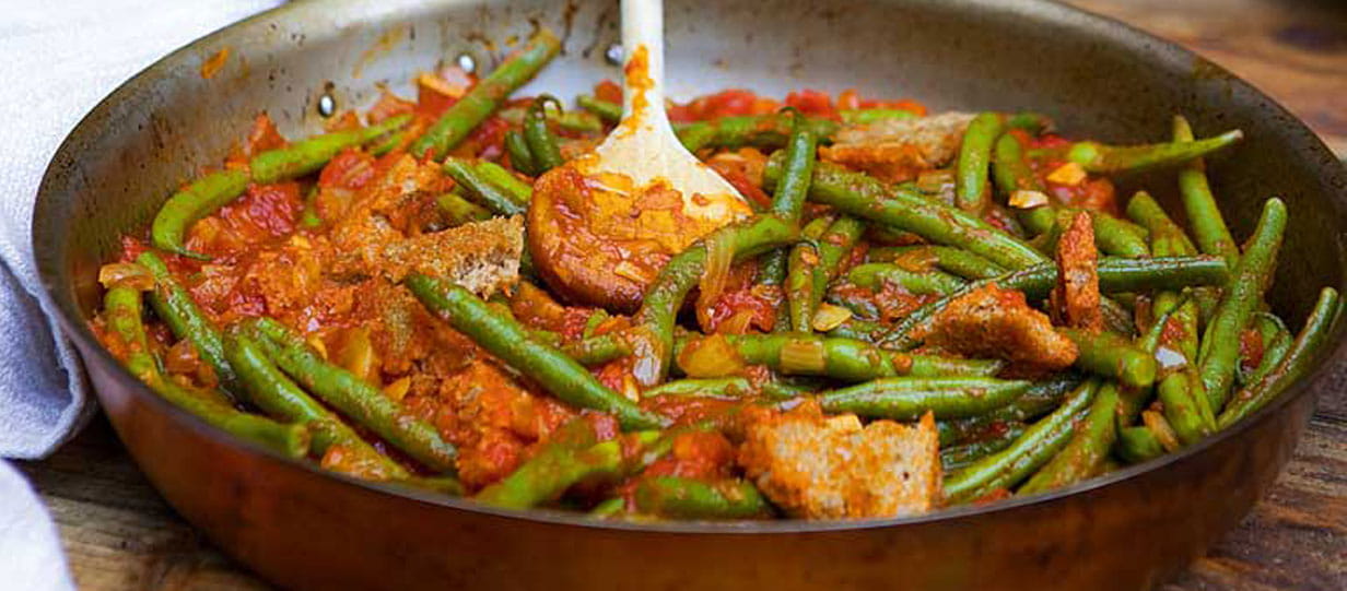 Deep pan of green beans and tomatoes