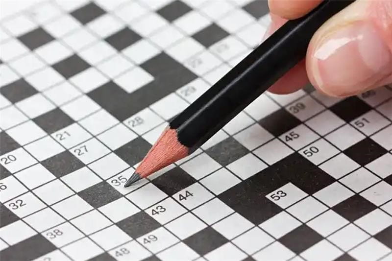 Someone completing a crossword puzzle