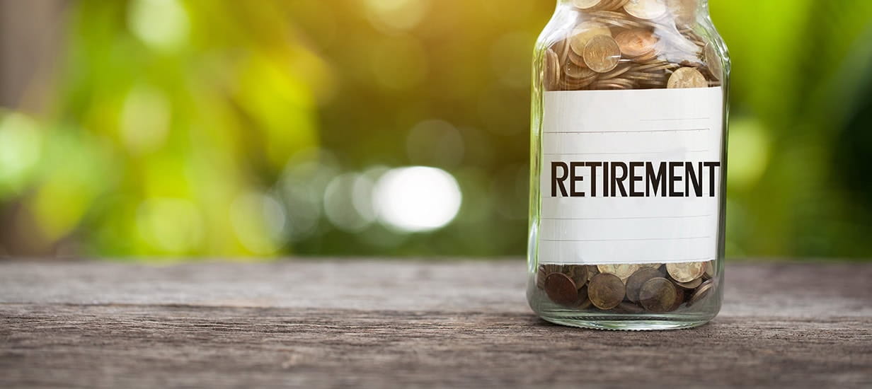 A jar full of coins with a label that reads 'retirement'