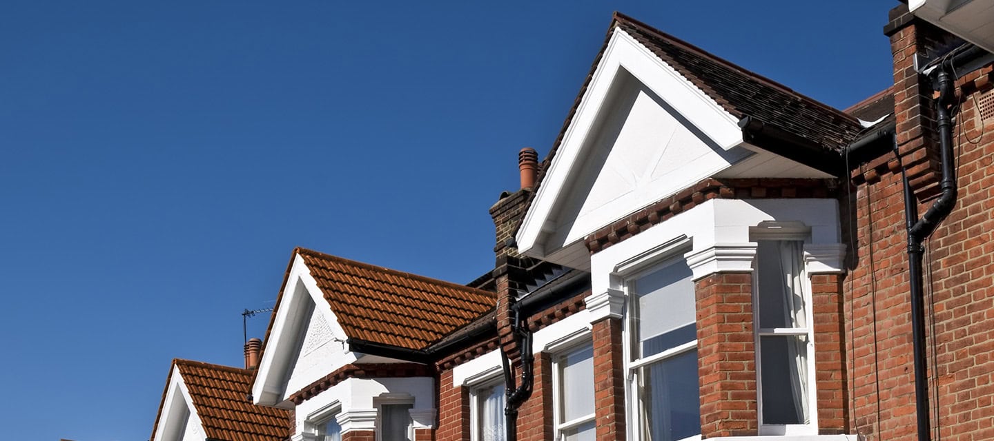 A row of houses on a blue sky day