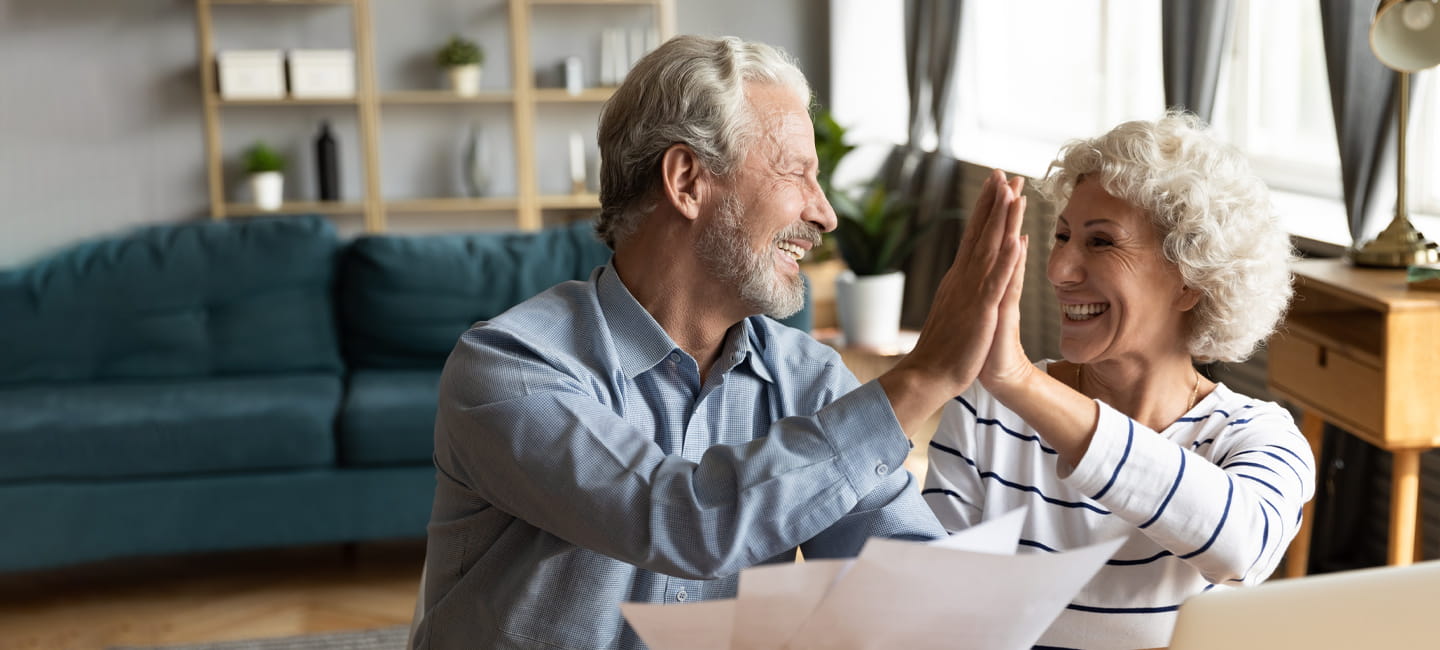 Two older people high fiving