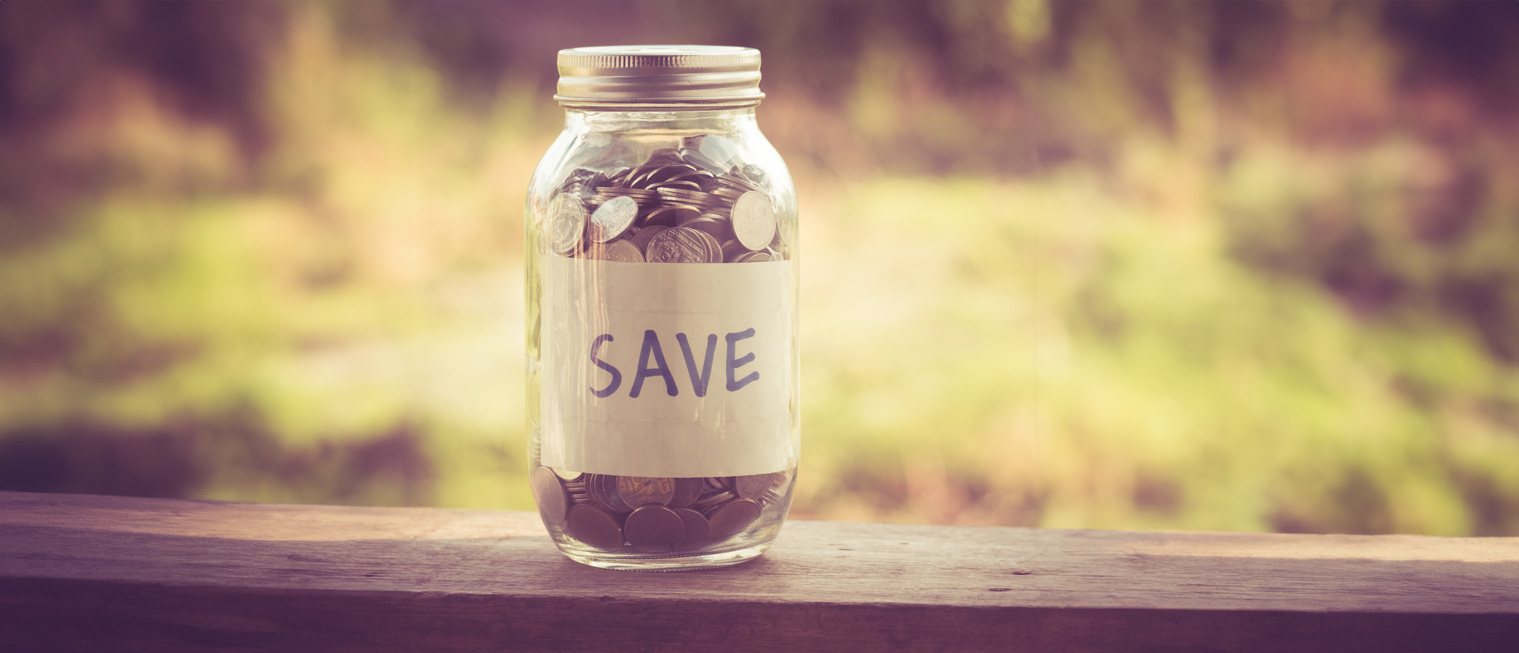 A jar of coins with a label that says save