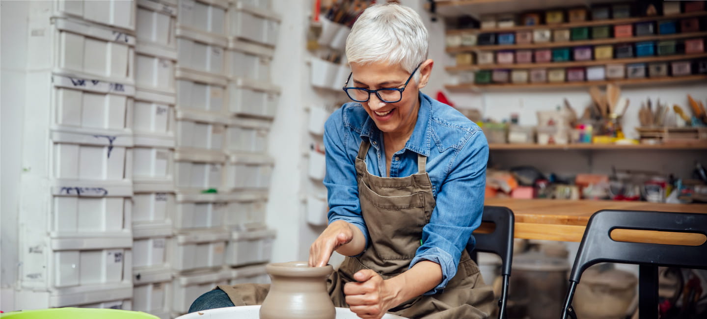 A woman working at a pottery wheel