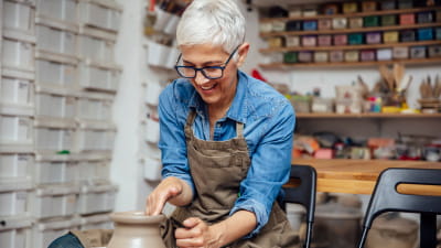 A woman working at a pottery wheel