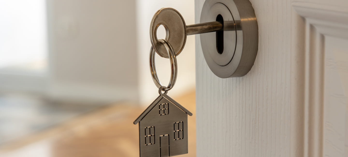 A key in a lock with a house key chain
