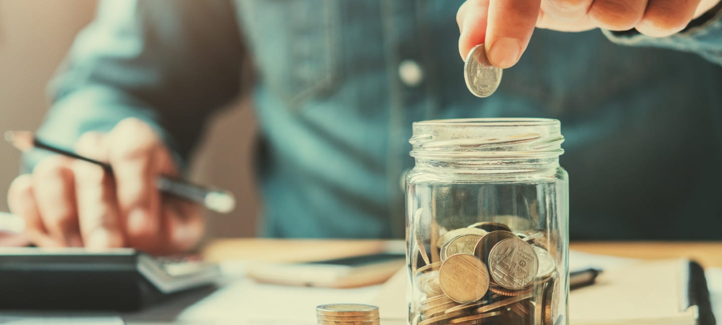 Man placing coins in jar