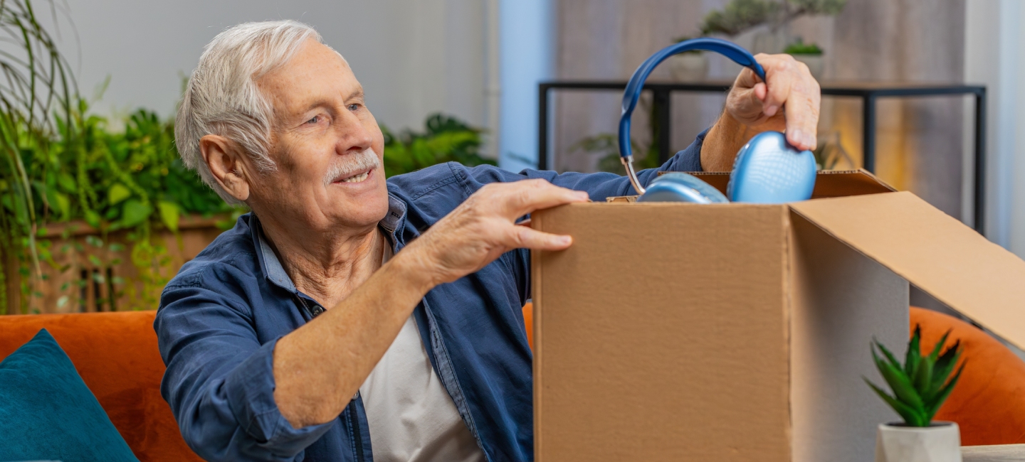 Man opening box and taking out headphones