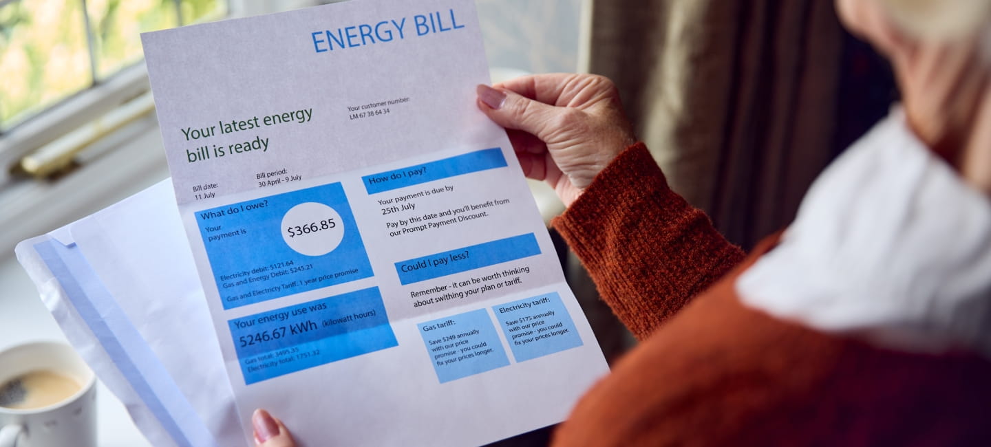 A person looking at a letter discussing their energy bill