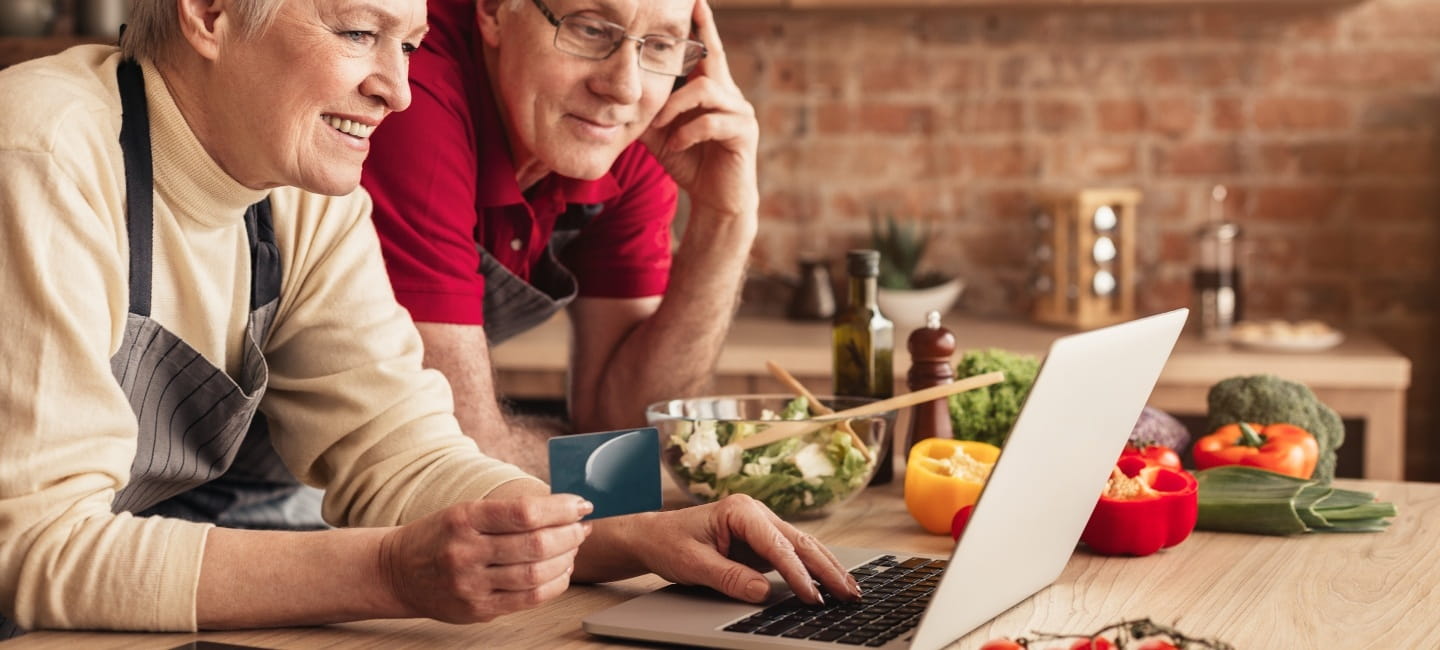 A couple staring at a laptop