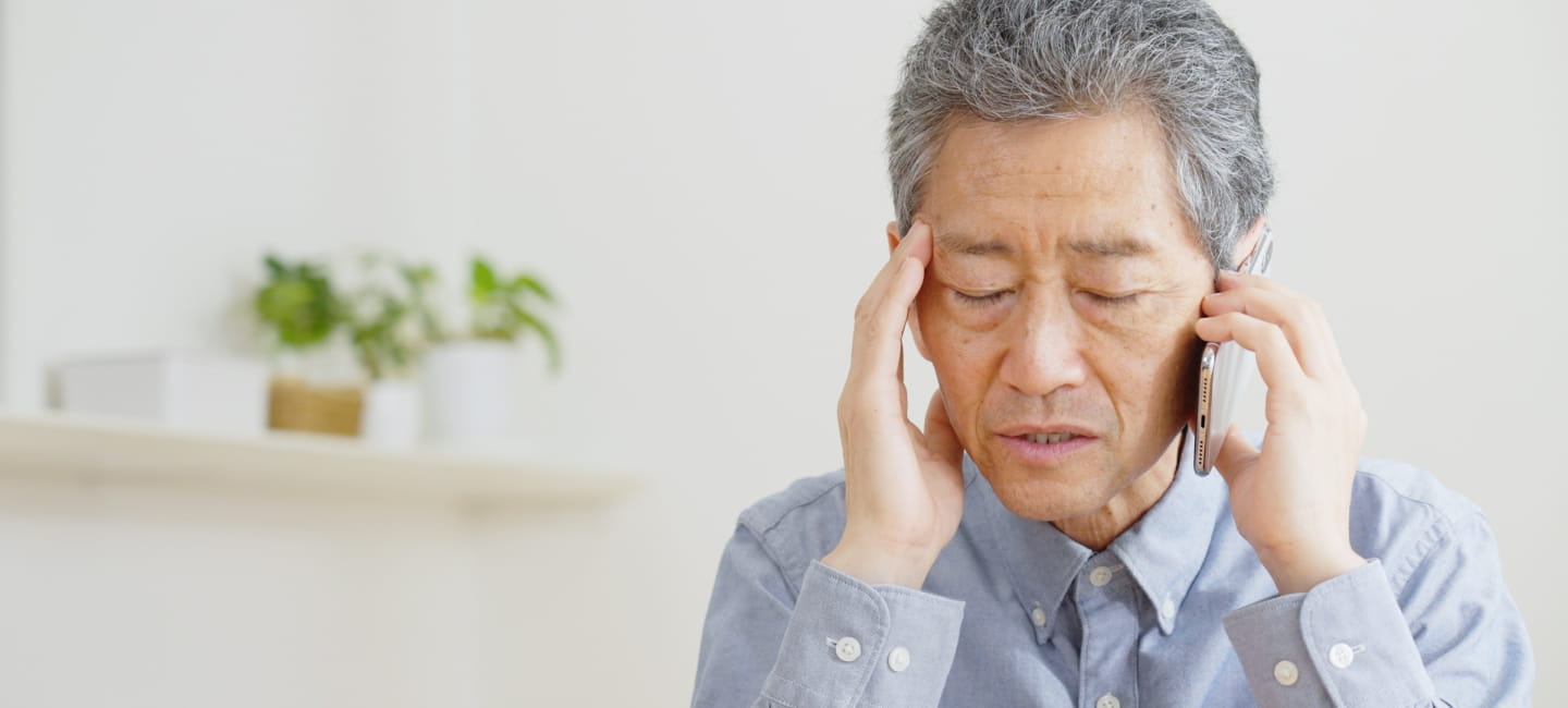 A man on the phone, looking slightly worried