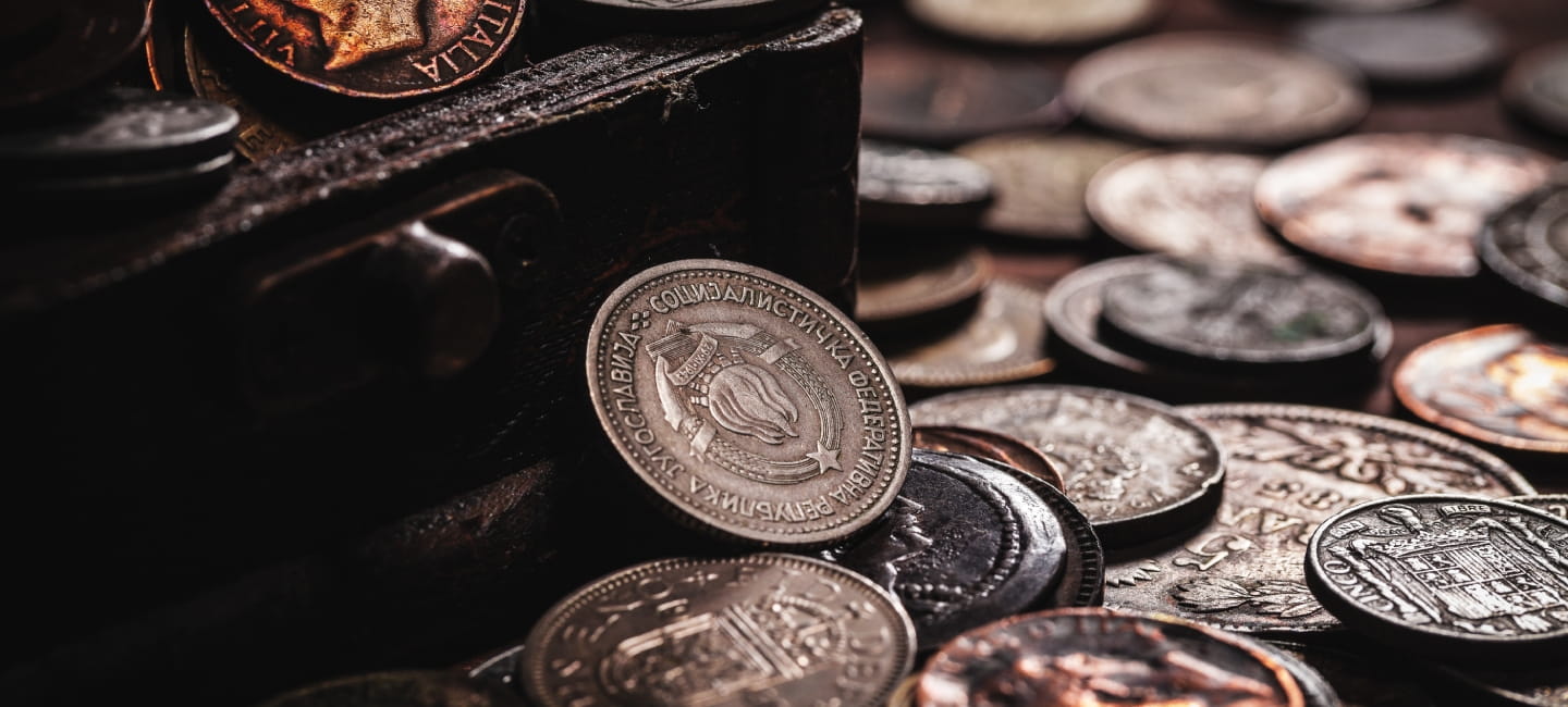 Lots of old coins spread out on a table