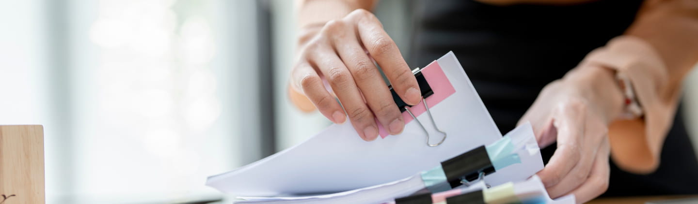 A woman sifting through paperwork