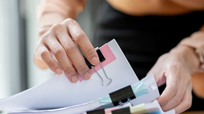 A woman sifting through paperwork