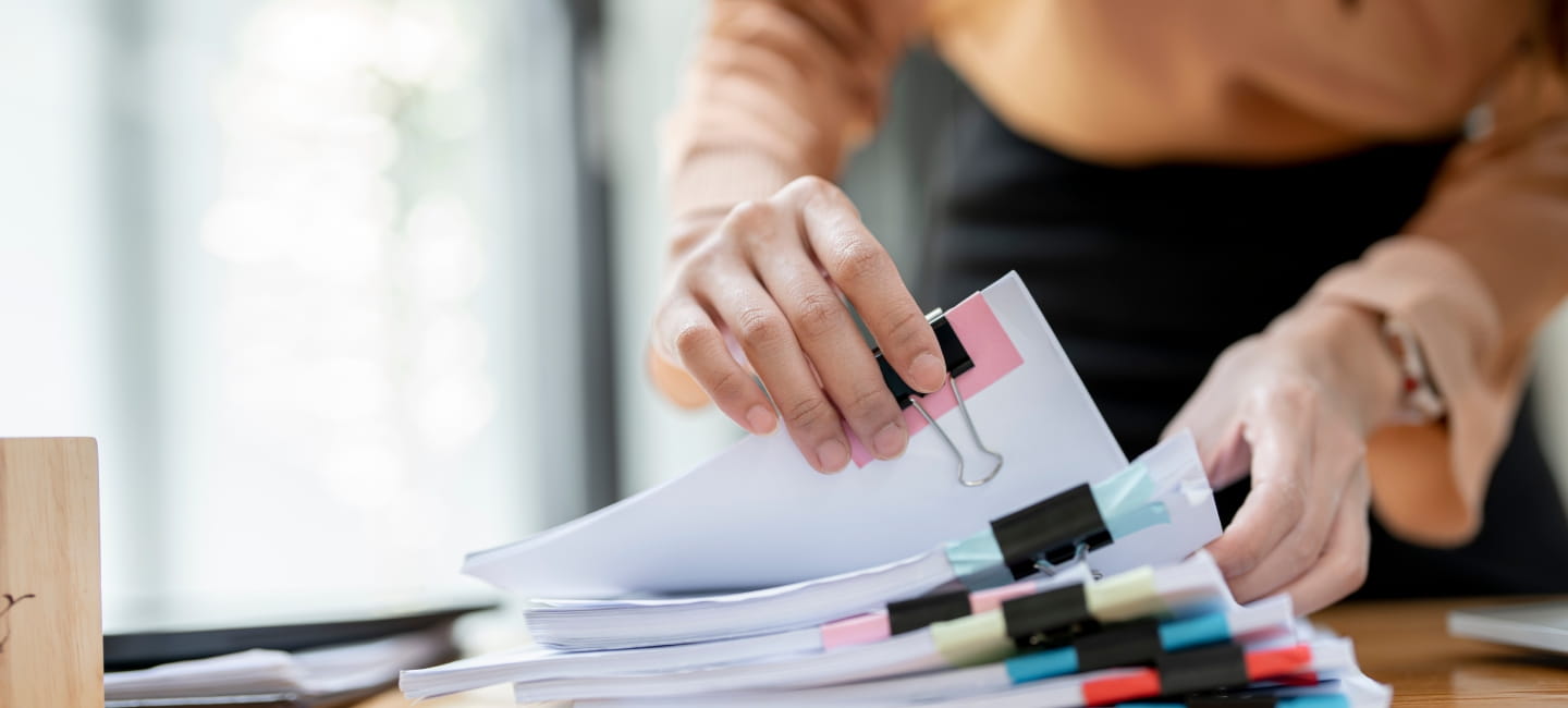 A woman sifting through paperwork