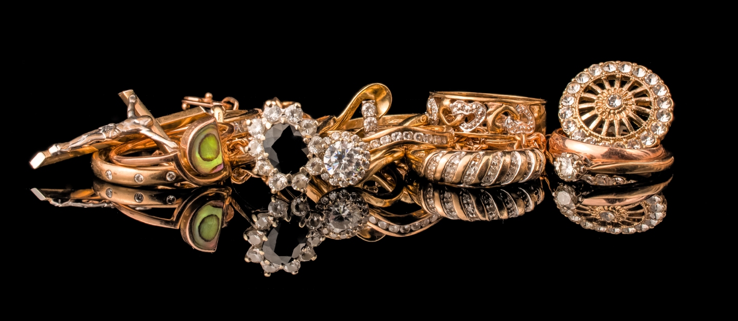 A golden scrap of old gold jewellery on black background